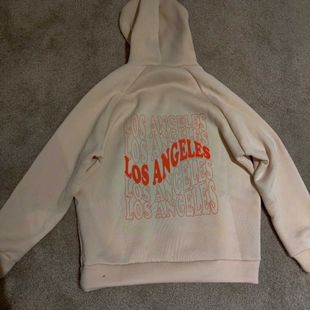 A soft hoodie with letters that say Los Angeles on the back.